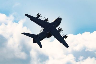 Low angle view of airplane flying in sky