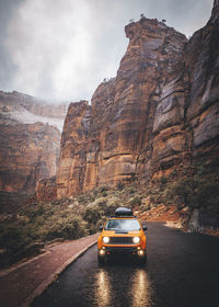 A car is on the rainy road in zion national park, utah