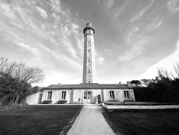 View of tower at port des baleines, against cloudy sky