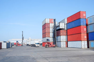 Built structure on pier amidst buildings against clear blue sky