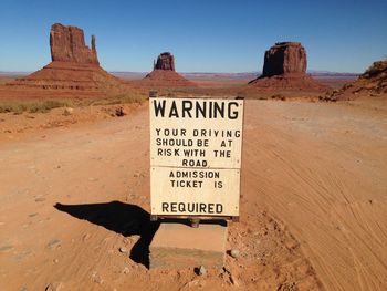 Warning sign on field at monument valley tribal park