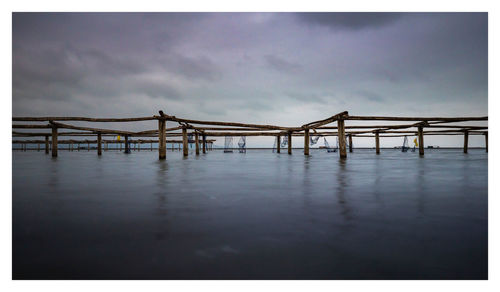 Pier over sea against sky