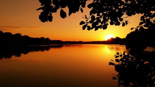 Scenic view of lake at sunset