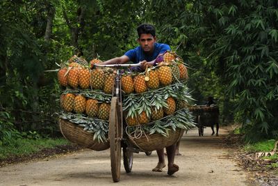 Rear view of woman holding food in farm