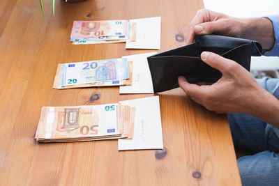 Midsection of man holding text on table