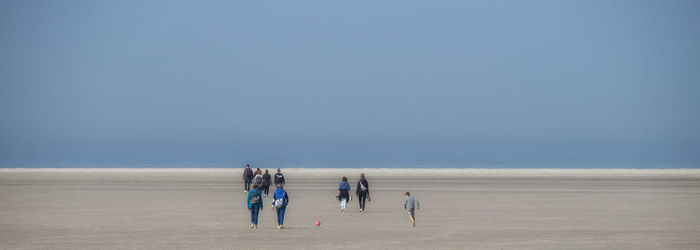 People on beach against sky