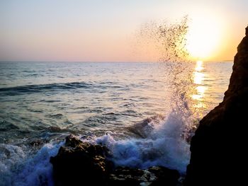 Scenic view of sea against clear sky during sunset