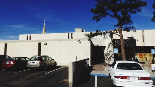 Vehicles parked on road along buildings