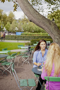 Two women sitting at outdoor cafe