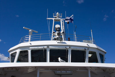 Boat sailing in sea against clear blue sky