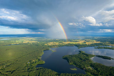 Aerial summer beautiful view of rainbow over the forest and lake, lithuania