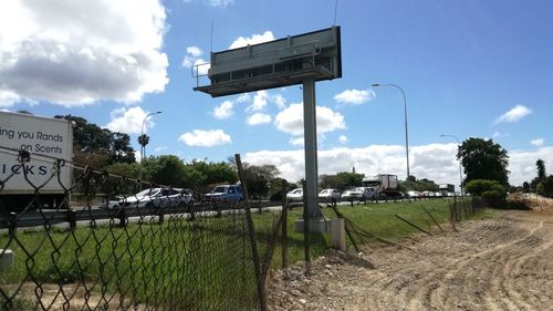 Information sign on footpath against blue sky