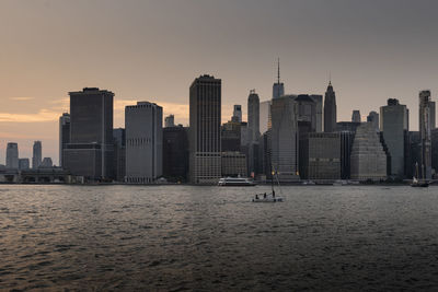 City at waterfront during sunset