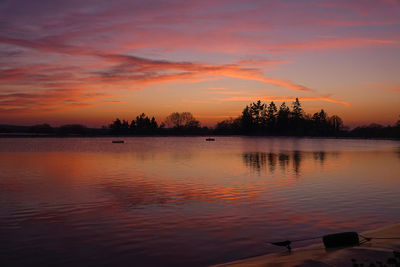 Scenic view of lake against orange sky