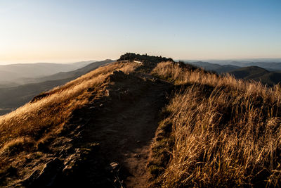 Scenic view of mountains against clear sky during sunset