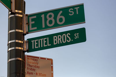 Low angle view of road sign against sky