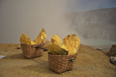 Baskets of sulphur out of ijen crater, indonesia