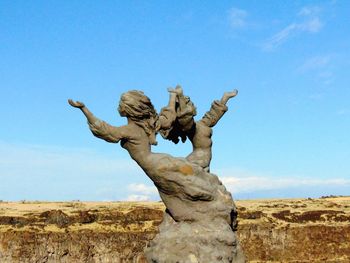 Low angle view of statue against blue sky