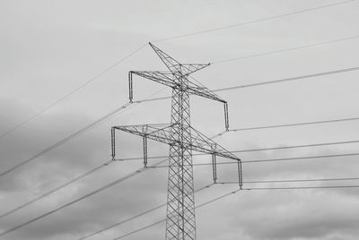 Low angle view of electricity pylon against sky