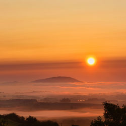 Scenic view of silhouette mountain against romantic sky at sunset sunrise