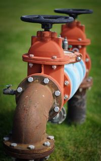 Close-up of machine part on field