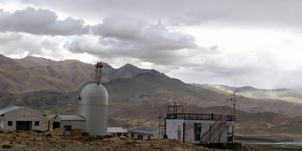 Panoramic view of building and mountains against sky