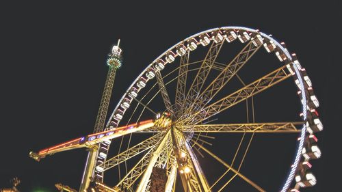 Low angle view of ferris wheel at night