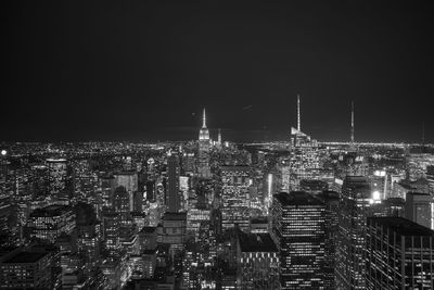 Bank of america tower and empire state building against sky in city at night