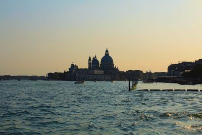 View of buildings against clear sky at sunset