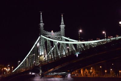 Low angle view of suspension bridge at night