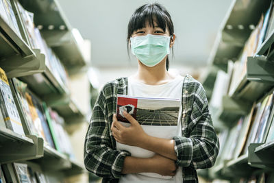 Portrait of young woman reading book