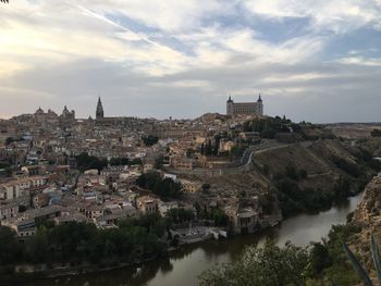 River amidst cityscape against sky