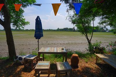 Chairs and table against field