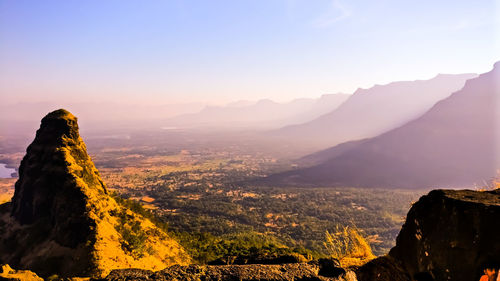 Scenic view of mountains against sky at sunset