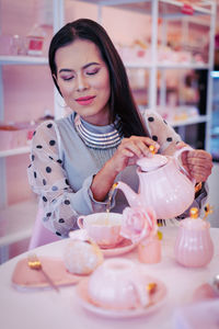Portrait of a smiling young woman holding ice cream