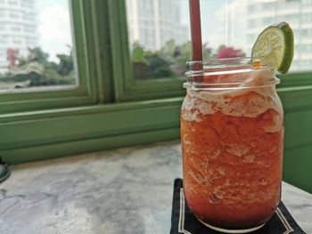 Close-up of drink in glass jar on table