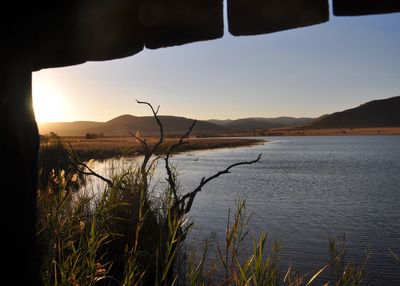 Scenic view of lake against sky during sunset