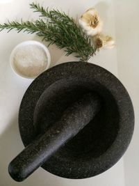 Directly above shot of mortar and pestle by ingredients in kitchen