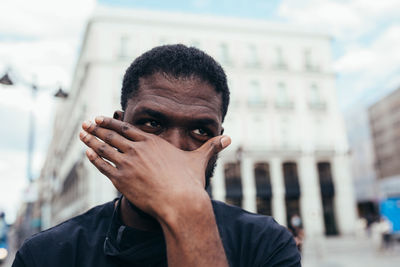 Portrait of young man in city