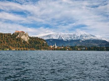 View of the snow-capped mountain peaks against the lake bled.