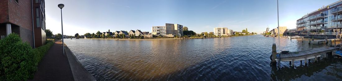 Panoramic view of river and buildings against sky