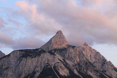 Low angle view of rocky mountain against sky