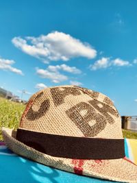 Close-up of hat on rock against sky
