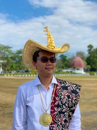 Young man wearing hat while standing outdoors