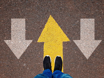 Low section of person standing on road