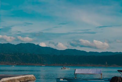 Scenic view of sea and mountains against sky