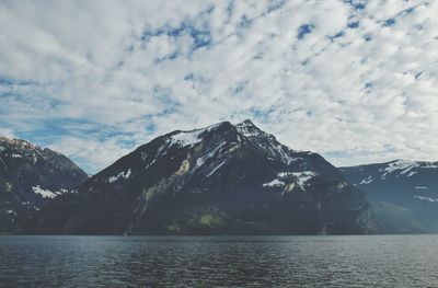 Scenic view of mountains against cloudy sky