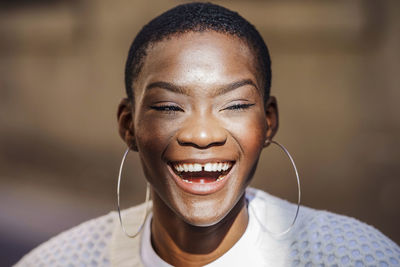Happy woman with gap toothed wearing hoop earrings