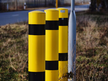 Close-up of yellow sign on field