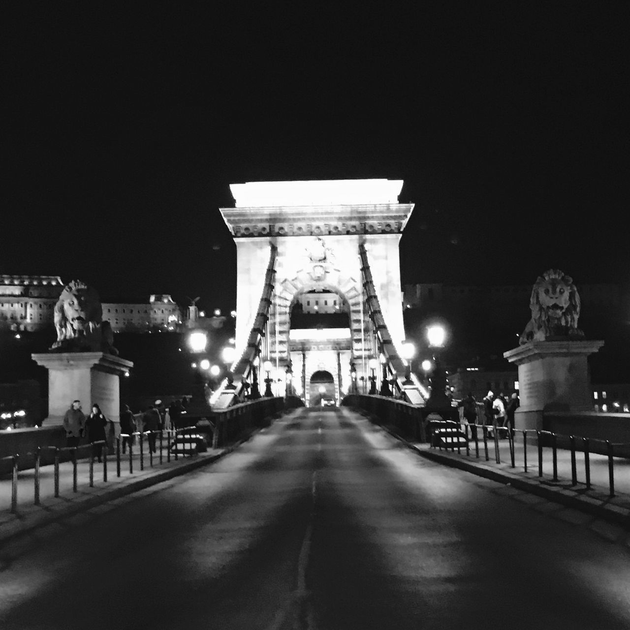 VIEW OF ILLUMINATED BRIDGE AT NIGHT